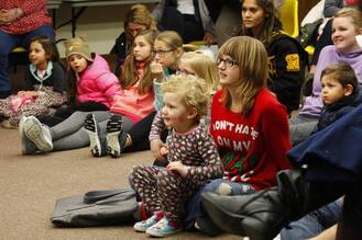 Kids listen to book at library storytime