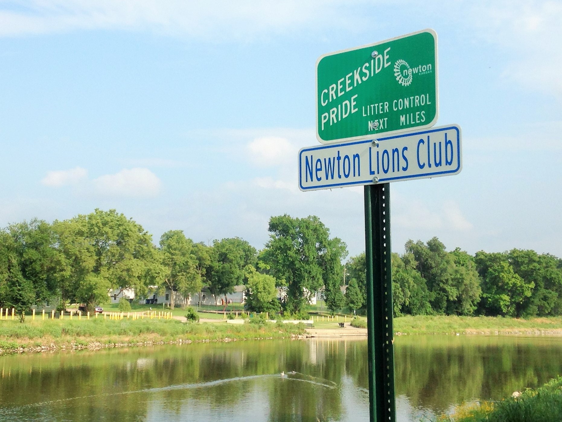 Creekside Pride sign next to Sand Creek