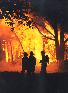 Firefighters spraying a house fire